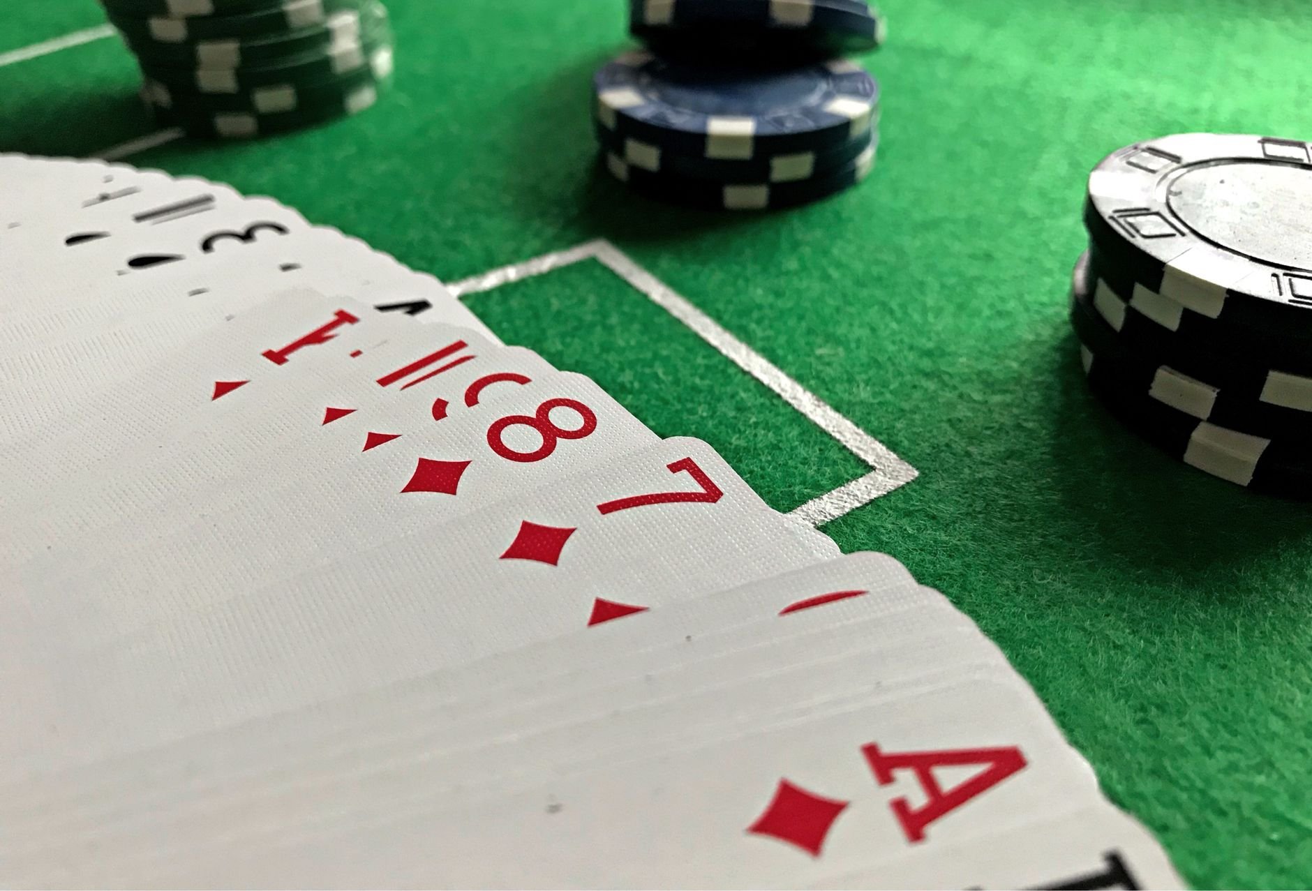 Sports trading cards spread on green felt — the Scorsed marketplace