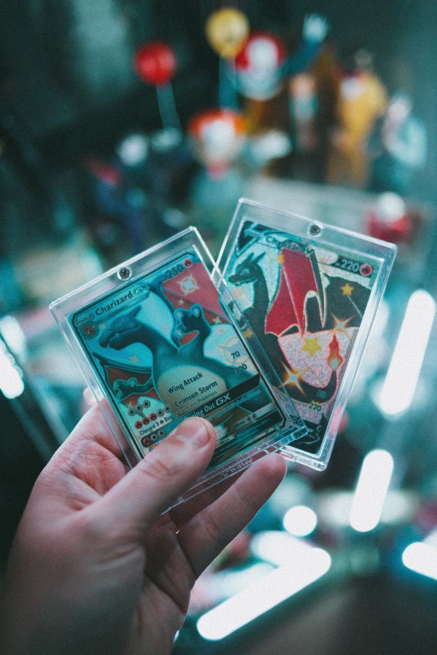 Close-up of a hand holding colorful trading cards